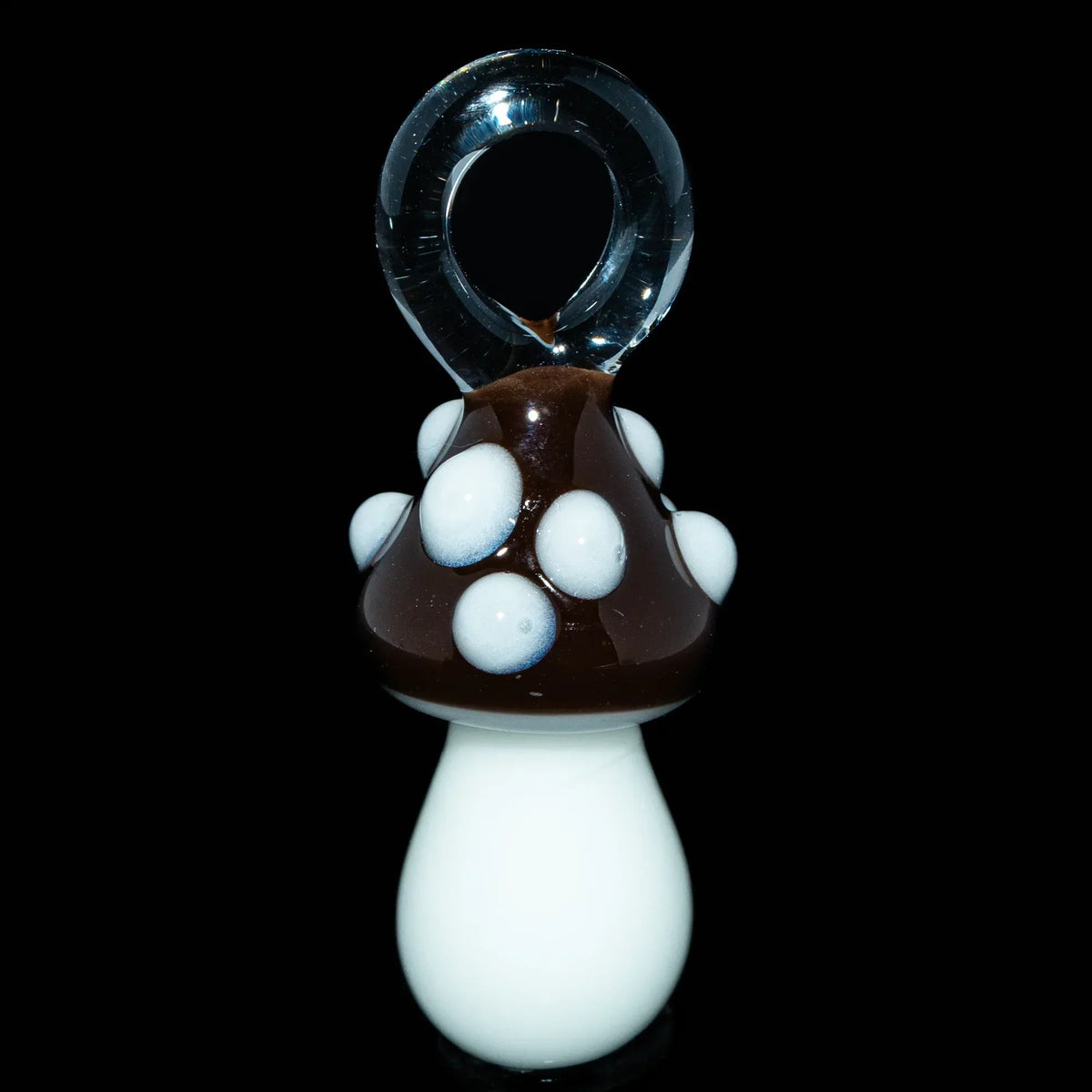 Brown and white glass mushroom pendant with loop on black background