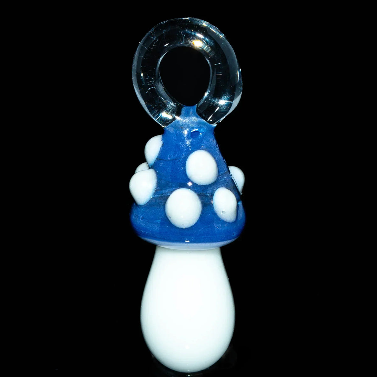 Hand-blown glass mushroom pendant with navy blue cap and white spots on black background