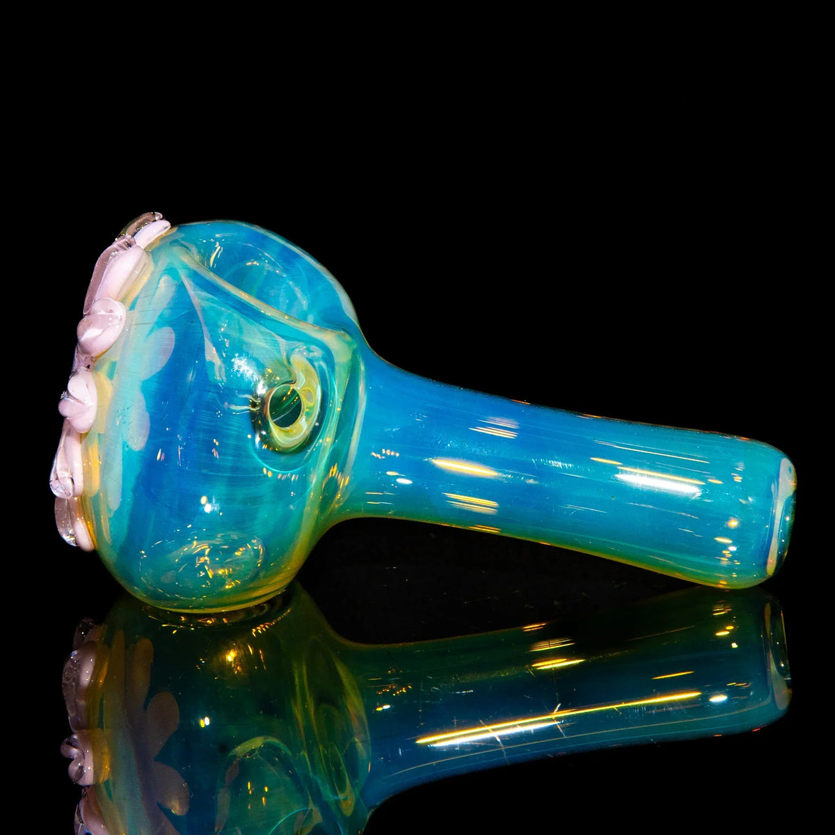 Blue glass spoon pipe with pink wildflower design on bowl, displayed on a black background