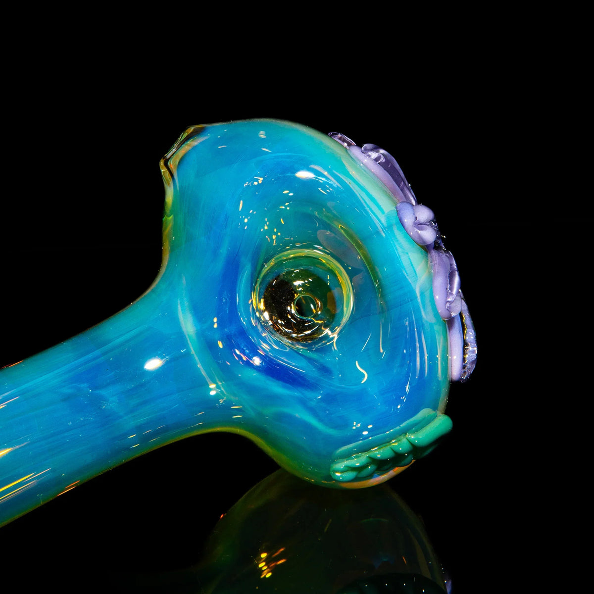 Handcrafted blue glass spoon pipe with purple wildflower accents on black background