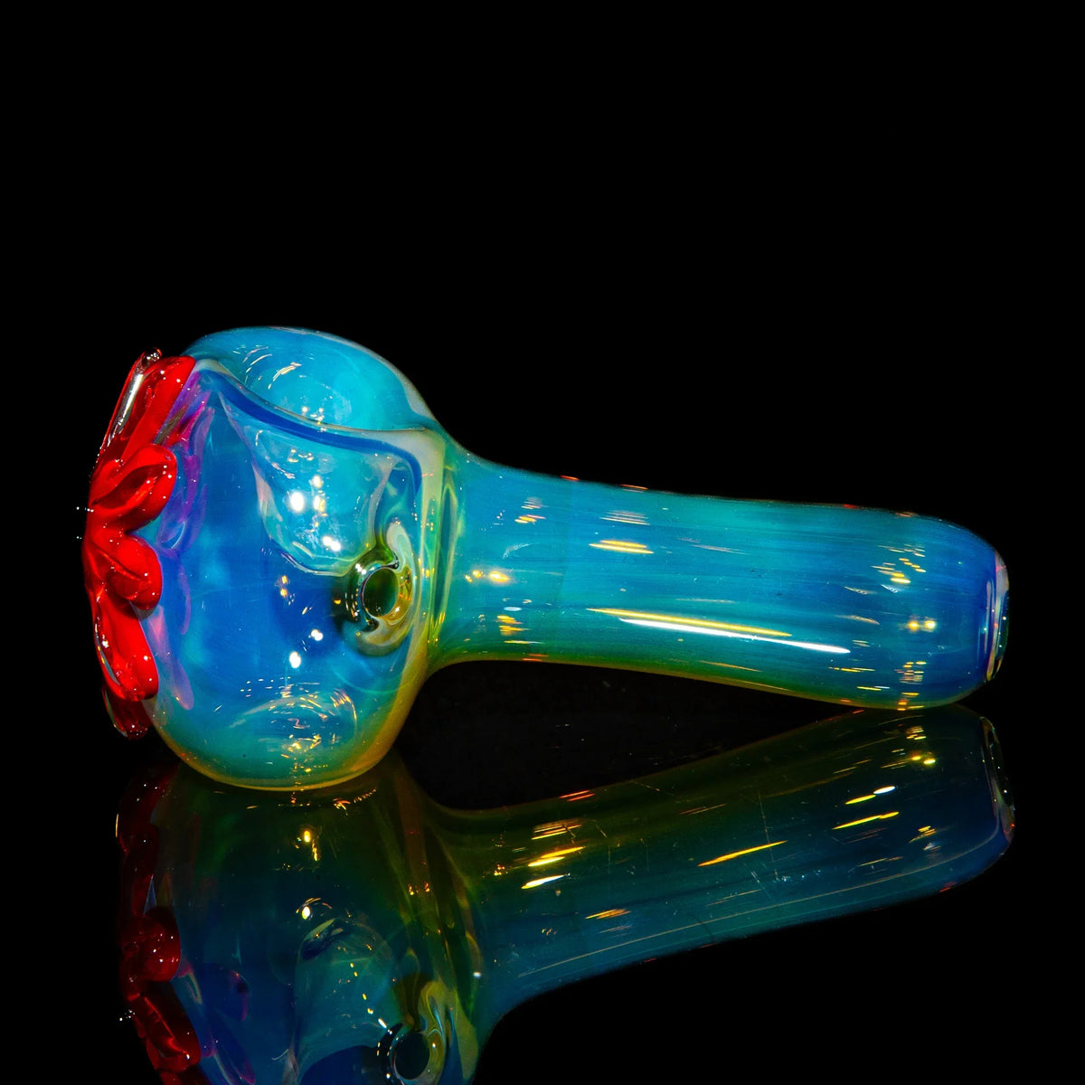 Colorful glass spoon pipe with red wildflower design on bowl, blue and green iridescent finish
