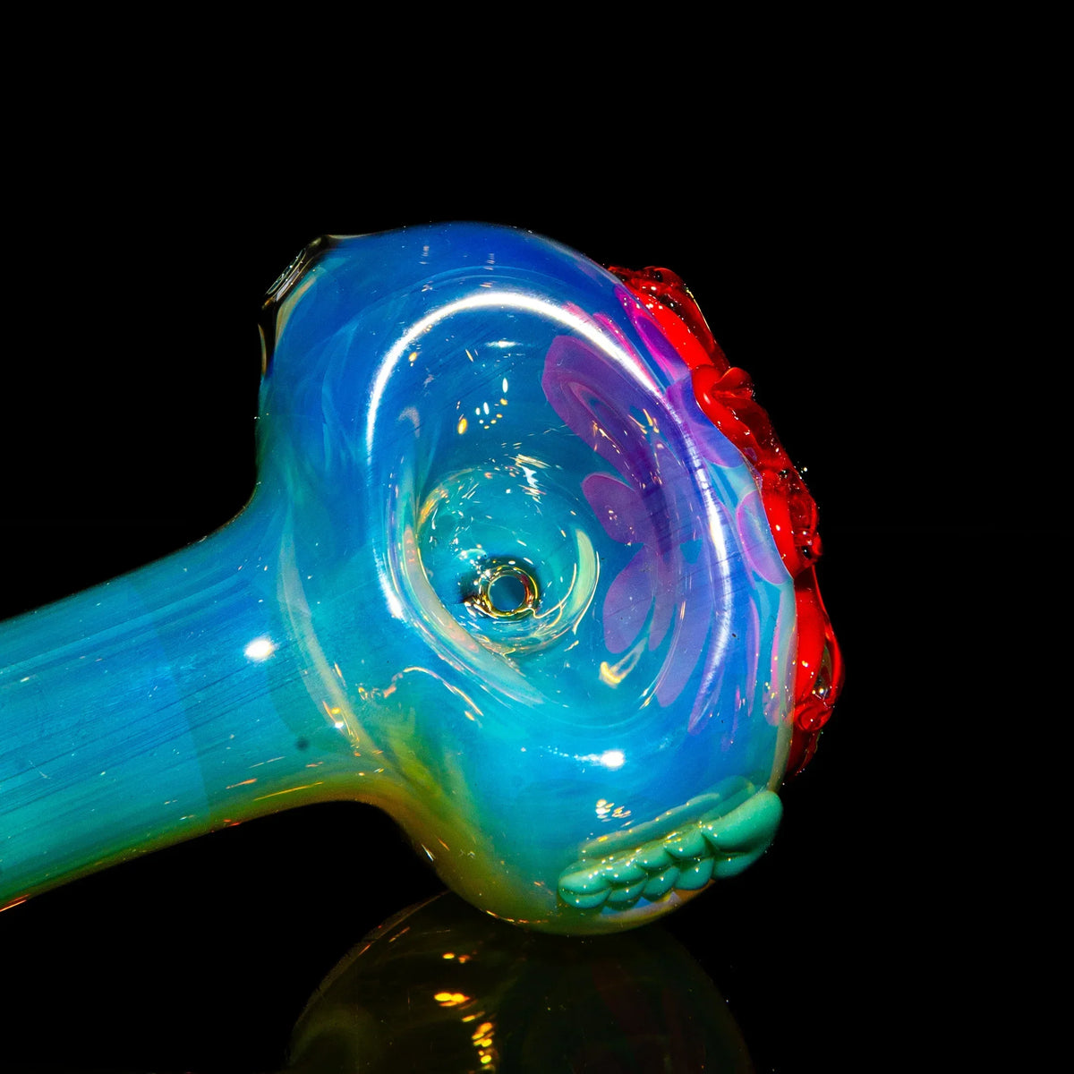 Colorful glass spoon pipe with red wild flower accents and blue iridescent finish