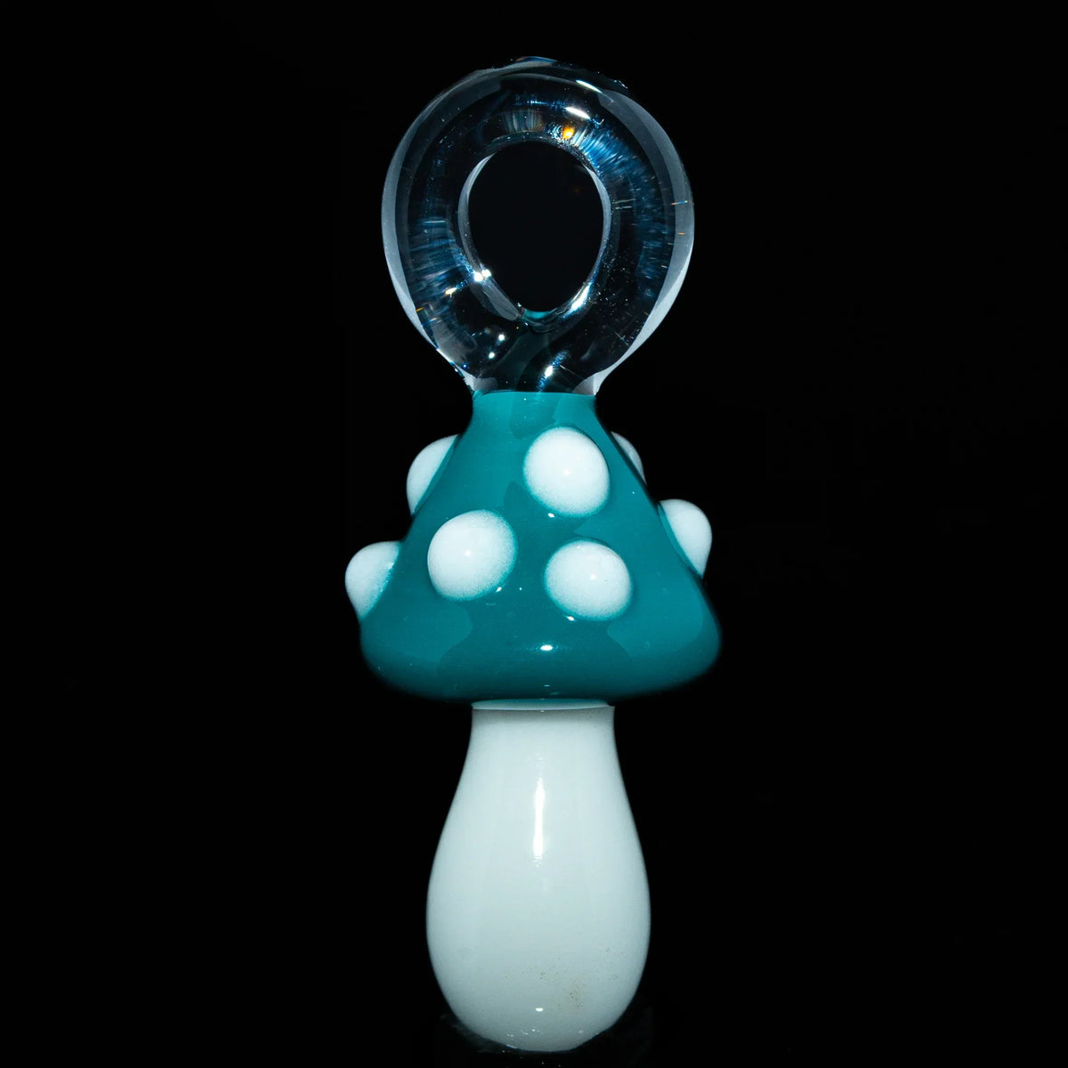 Teal mushroom glass pendant with white spots and a clear glass loop on black background