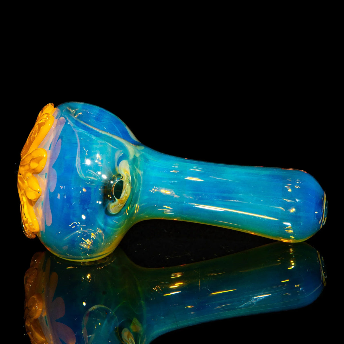 Blue and yellow glass spoon pipe with wildflower design on black background