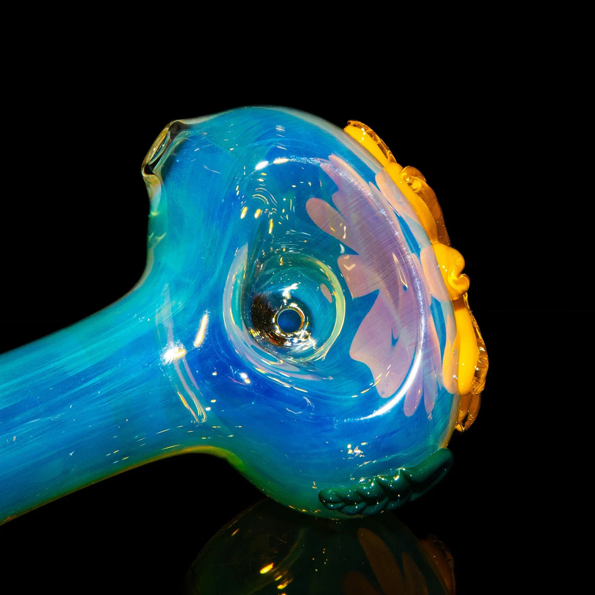 Blue glass spoon pipe with yellow wildflower design on black background