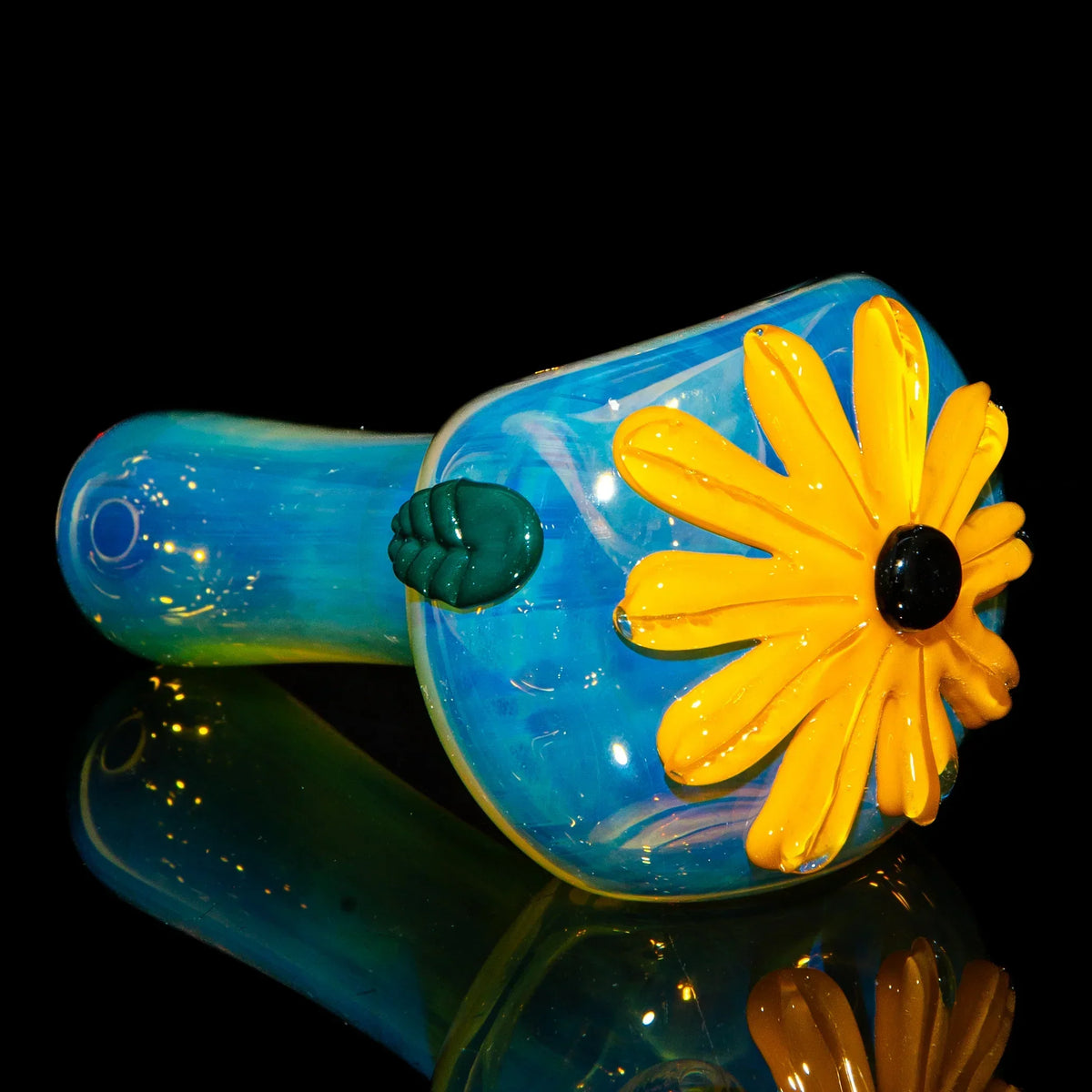 Blue glass spoon pipe with vibrant yellow wildflower design on black background