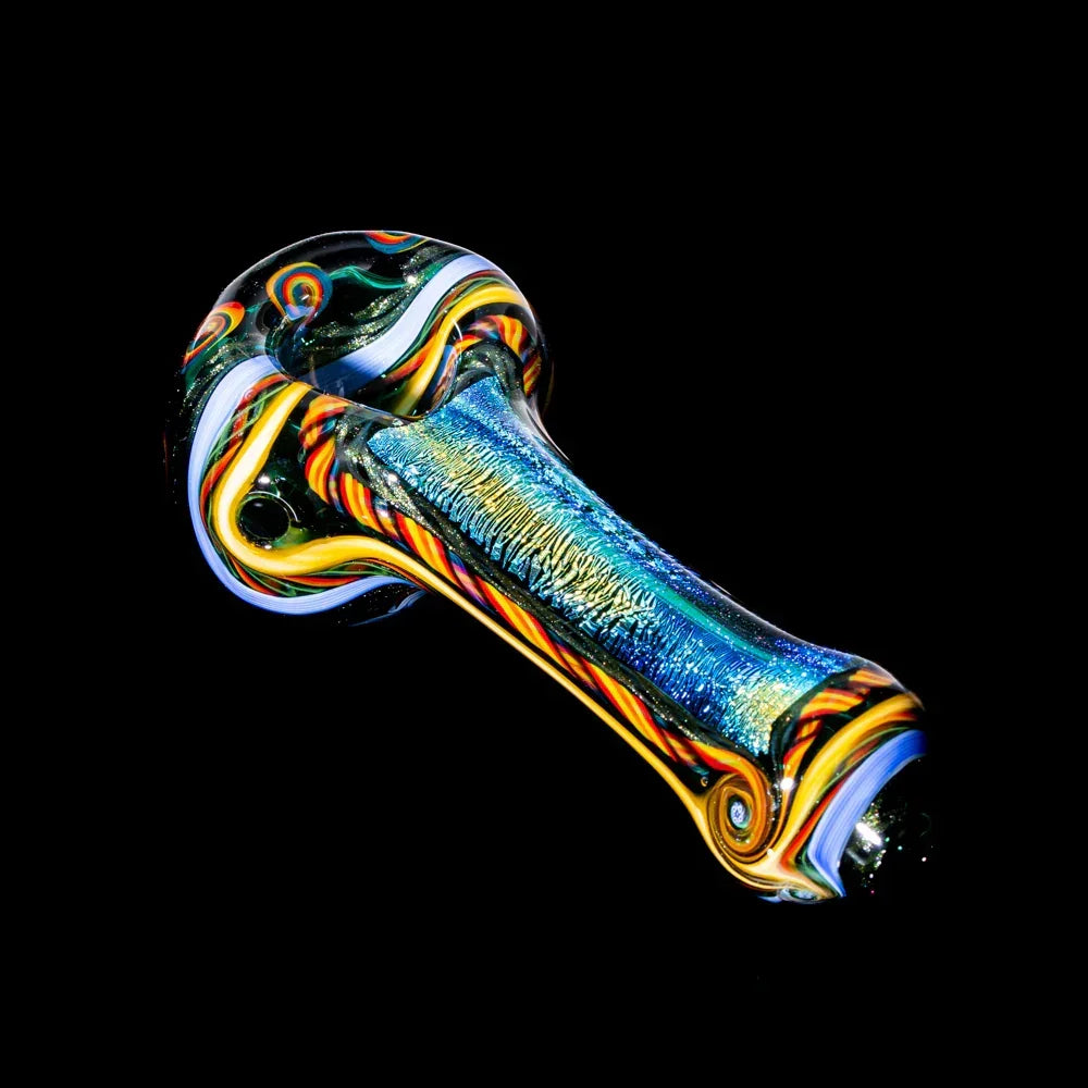 Colorful blue and yellow glass hand pipe with swirling patterns on black background