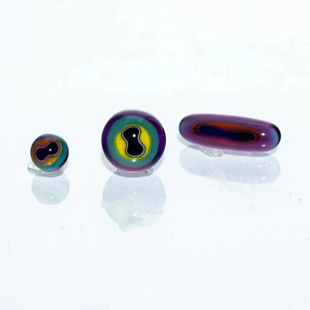 Colorful glass carb cap and terp pearls set on a white background, rainbow swirled design.