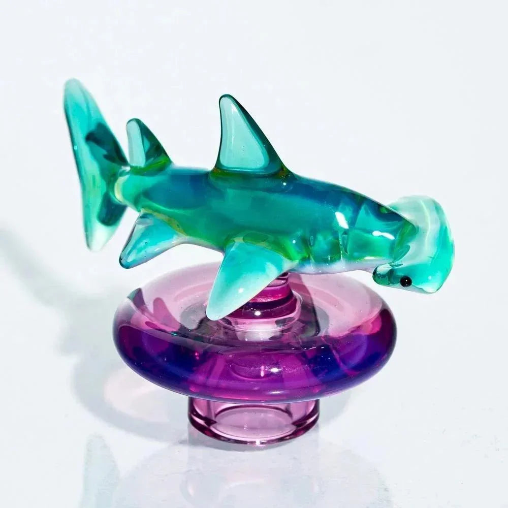 Glass hammerhead shark carb cap on a purple glass plug for smoking accessories
