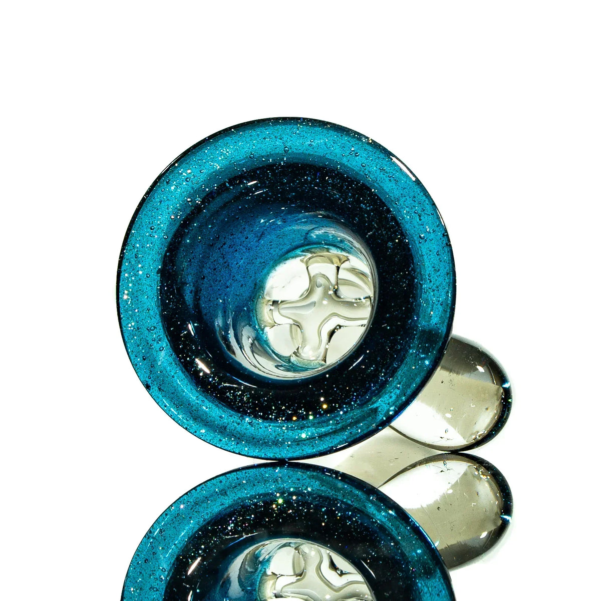 Heavy blue stardust glass slide with four-hole design, shown on reflective surface