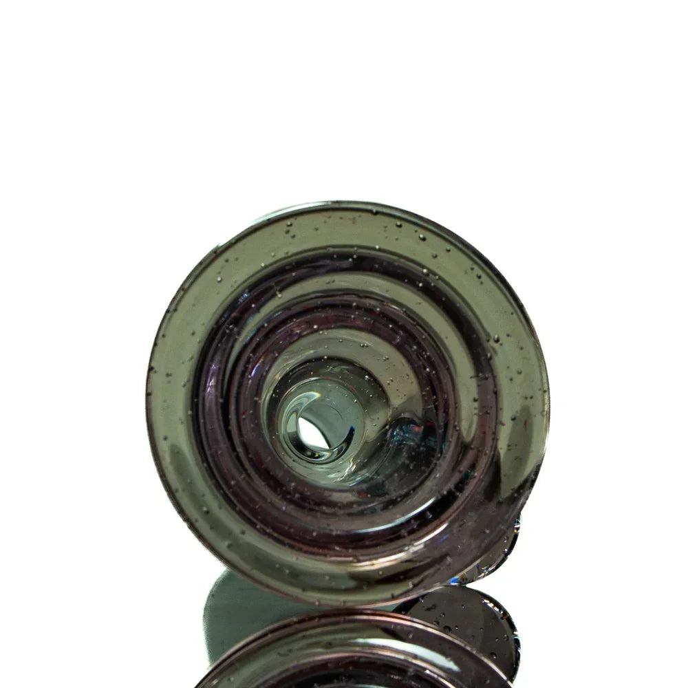 Close-up view of a clear glass slide bowl with bubble details, smoking accessory
