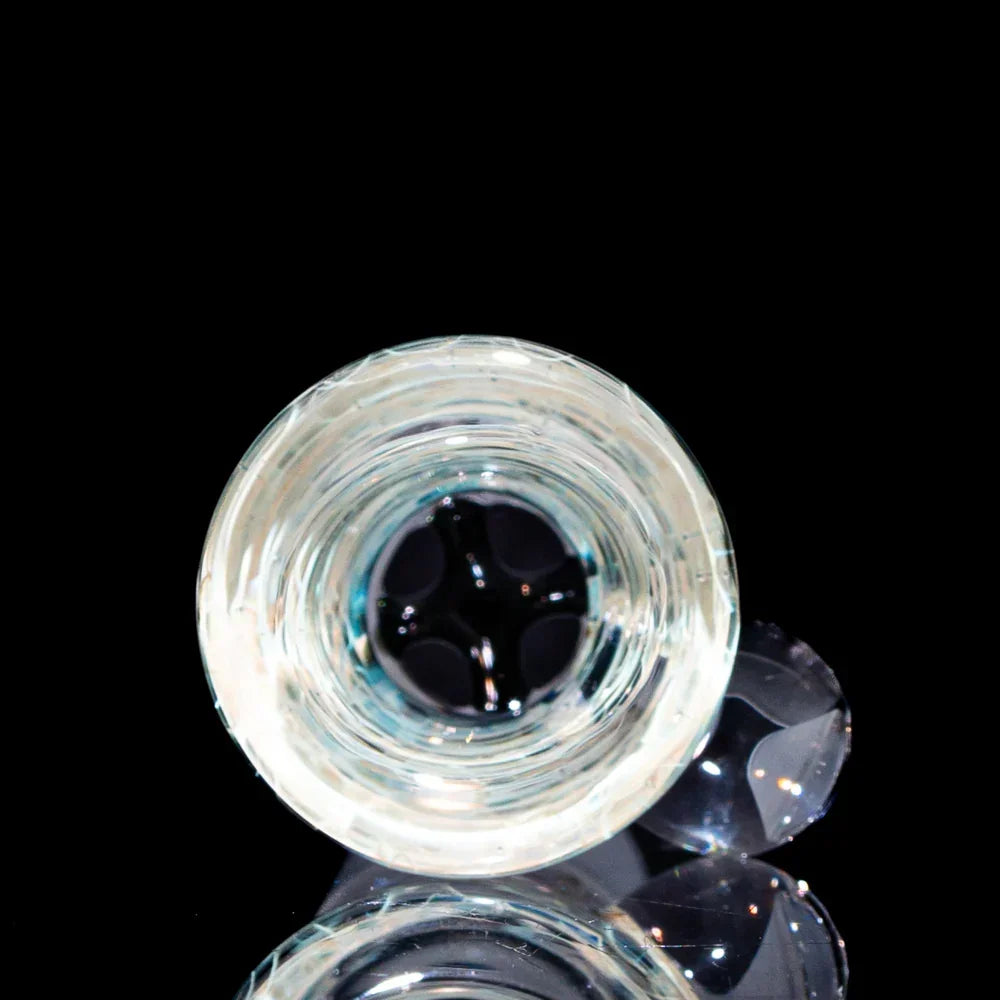 Clear glass four-hole martini slide with silver fume wrap on a black background