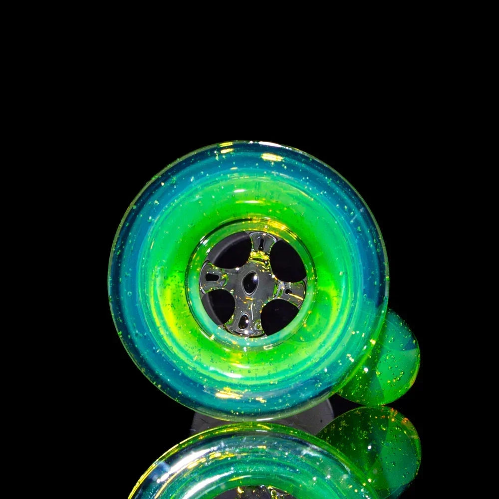 Slyme green 18mm four-hole glass slide with colorful accents on black background