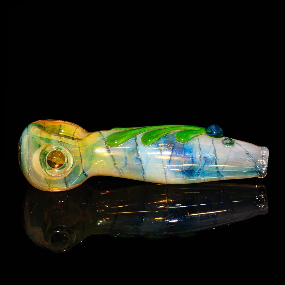 Handcrafted glass spoon pipe with green and blue swirls on a black background