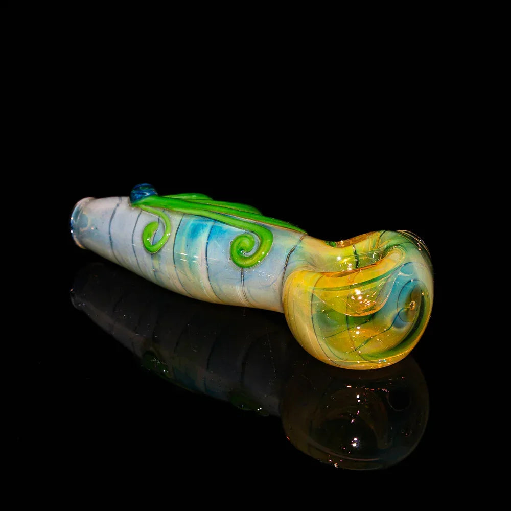 Colorful glass hand pipe with green swirl design and yellow bowl on black background
