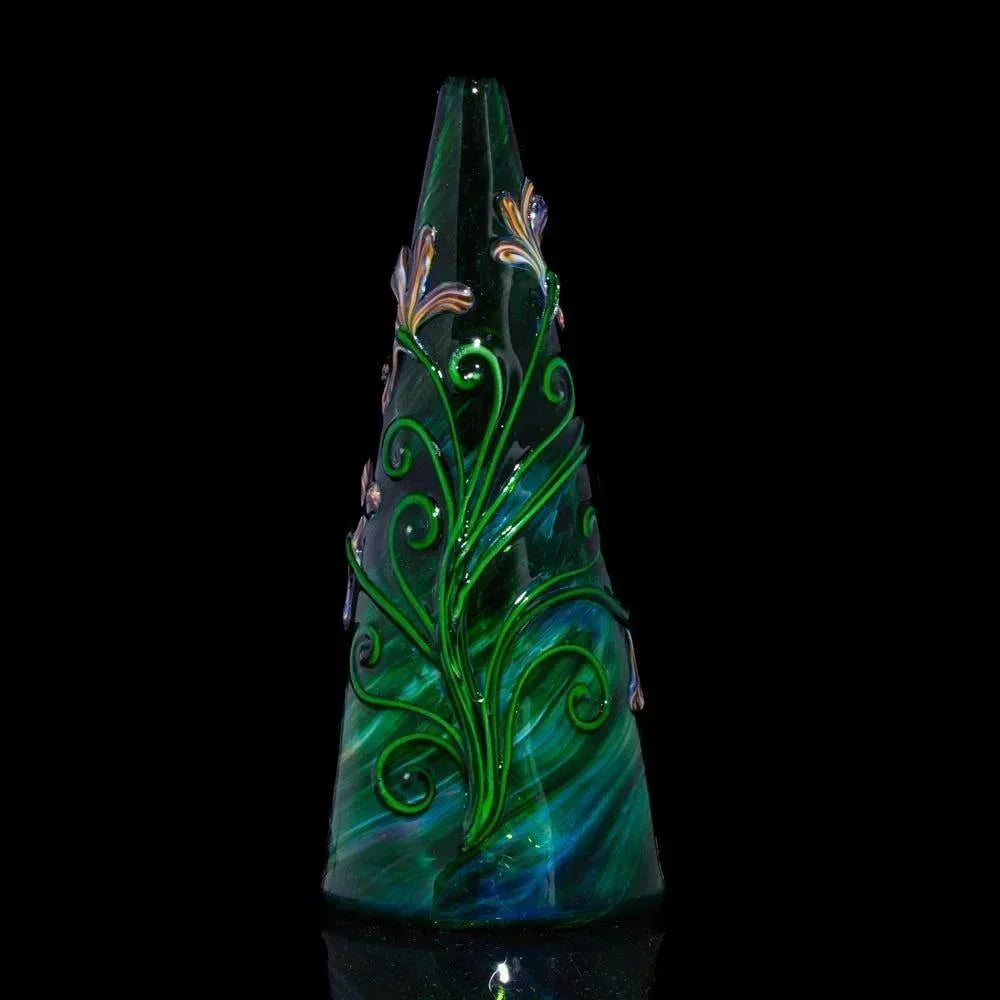 Green glass rig with floral design and vine details on a black background