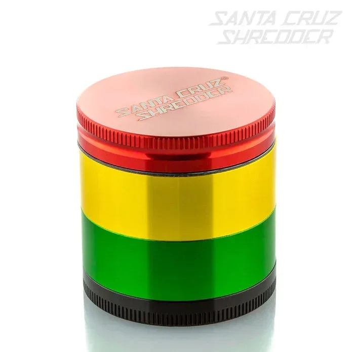 Colorful metal herb grinder with red, yellow, and green bands on a white background