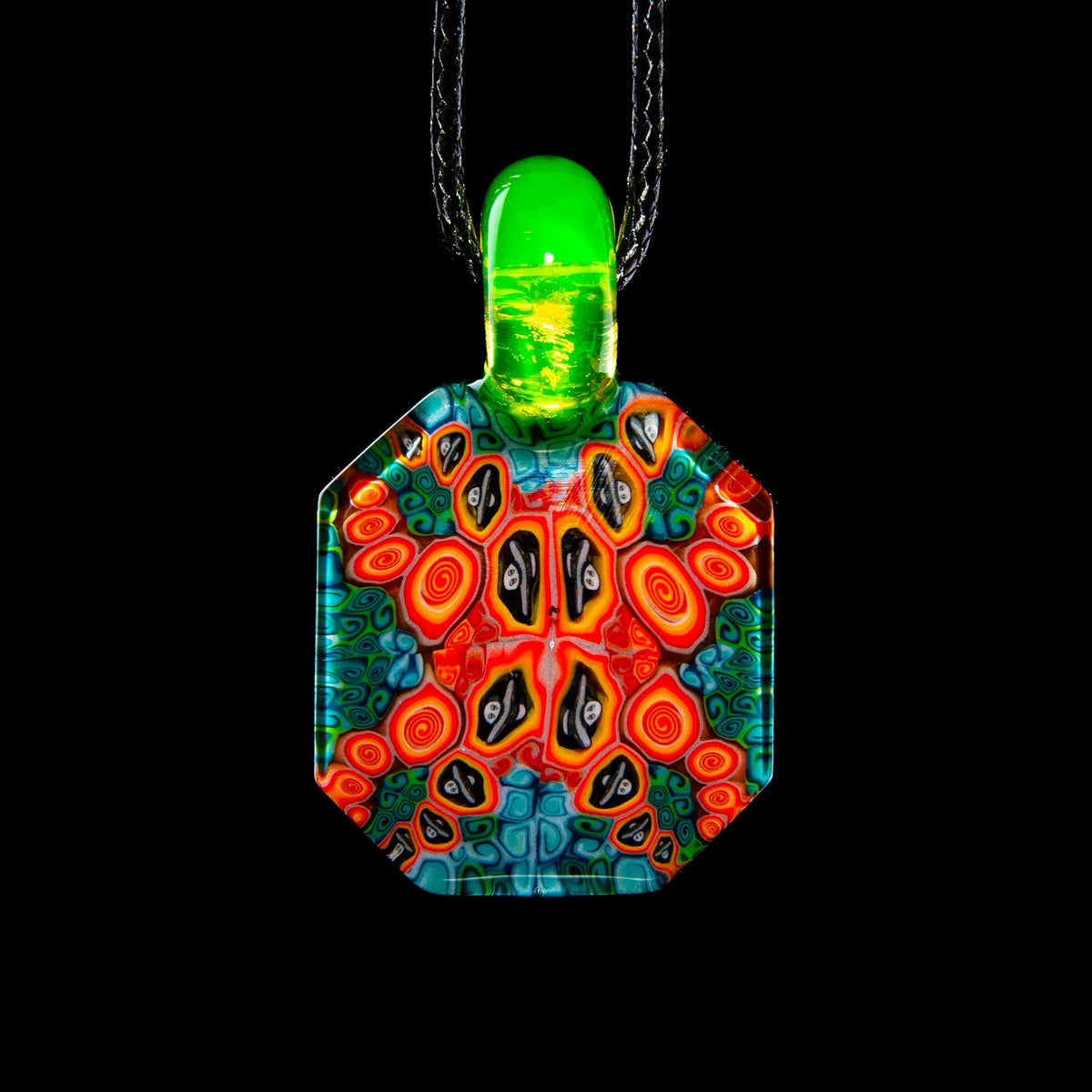 Large glass pendant with vibrant psychedelic patterns and green glass top on black cord