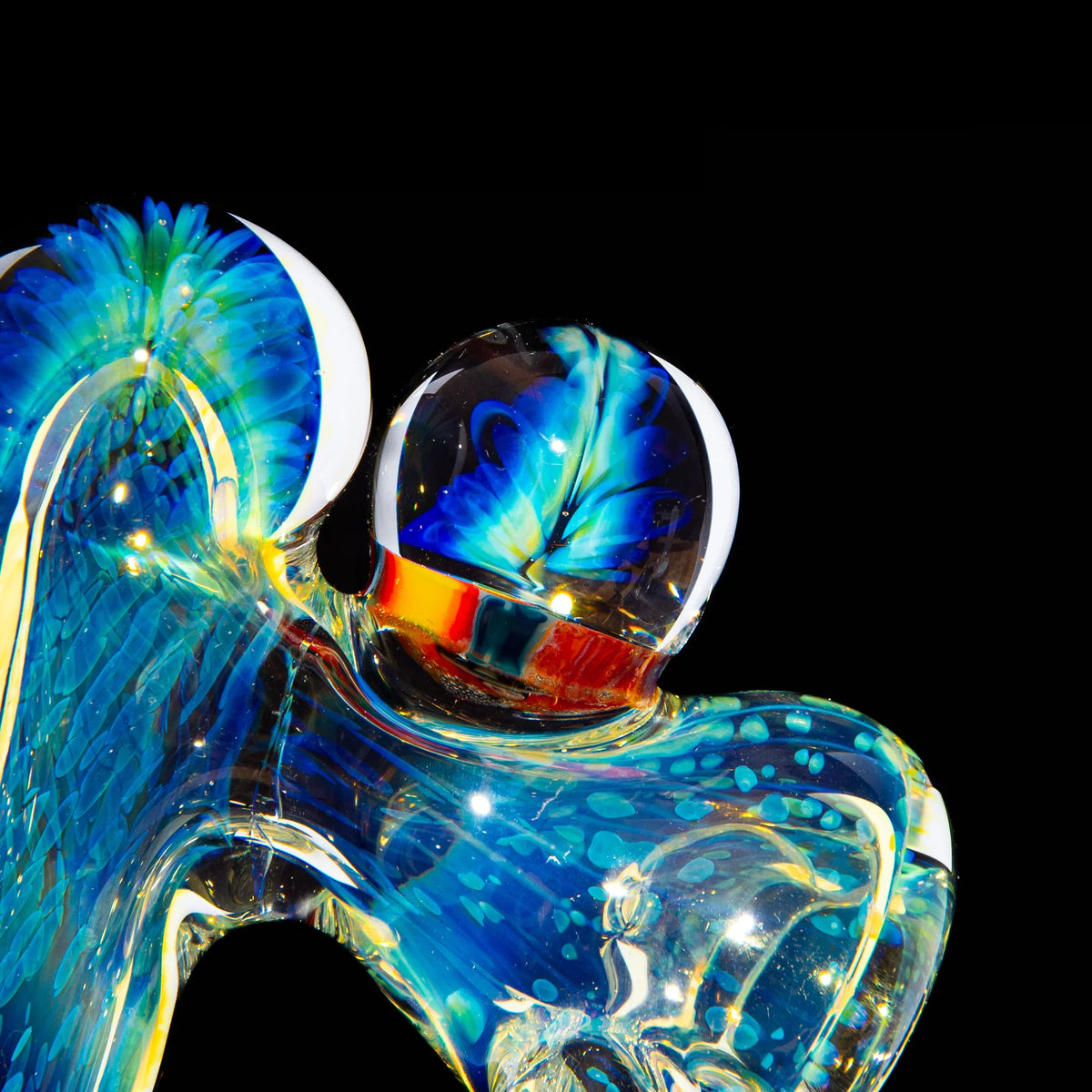 Colorful hand-blown glass pipe with blue and yellow accents on a black background