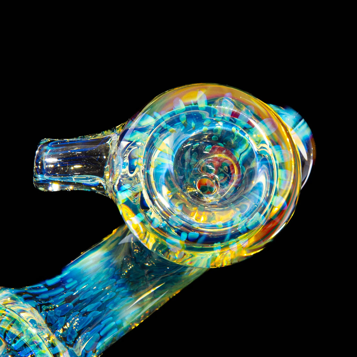 Colorful glass hand pipe with blue and yellow swirls on a black background