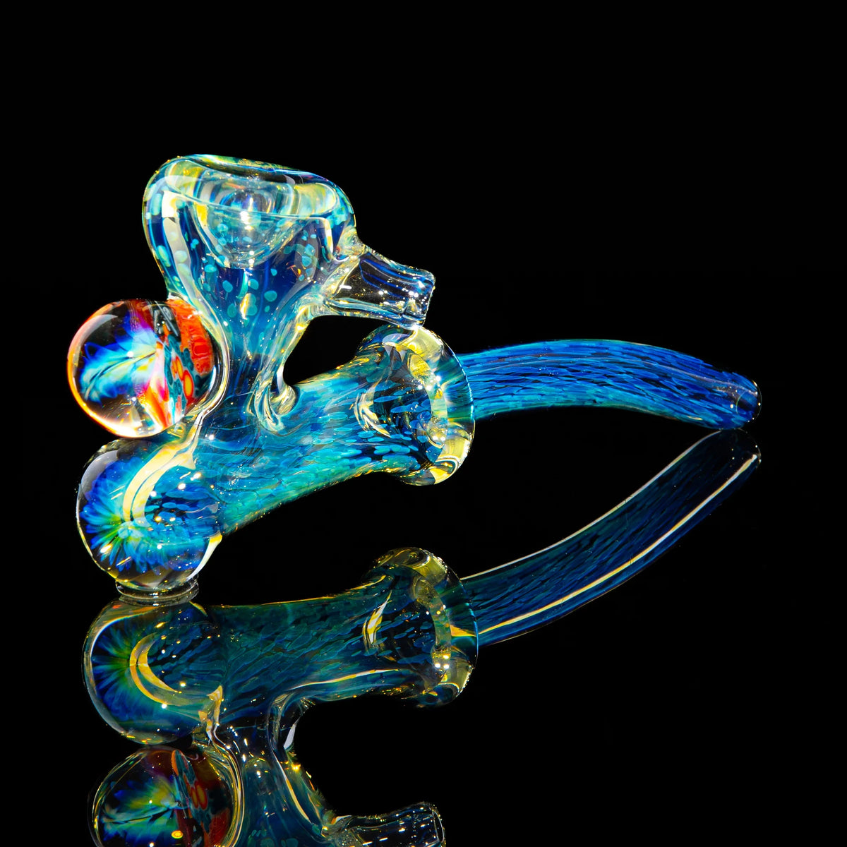 Colorful hand-blown glass pipe with blue and yellow patterns, shown on a black background