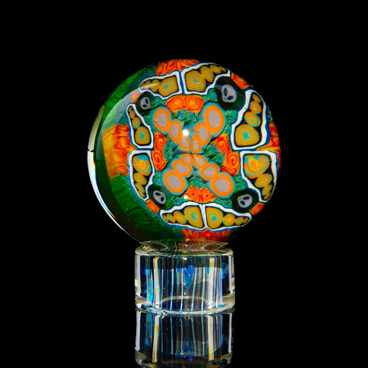 Colorful marble art glass with intricate patterns on a clear stand against a black background.