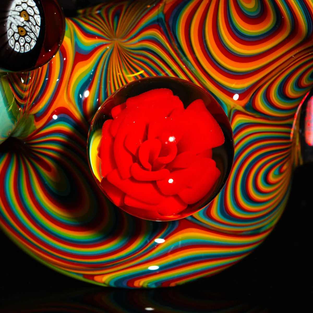 Heady glass pipe with vibrant rainbow swirls and a red glass flower accent