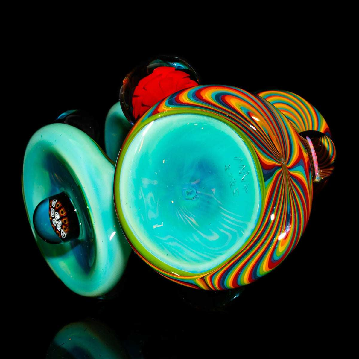 Colorful hand-blown glass pipe with swirling rainbow patterns on a black background