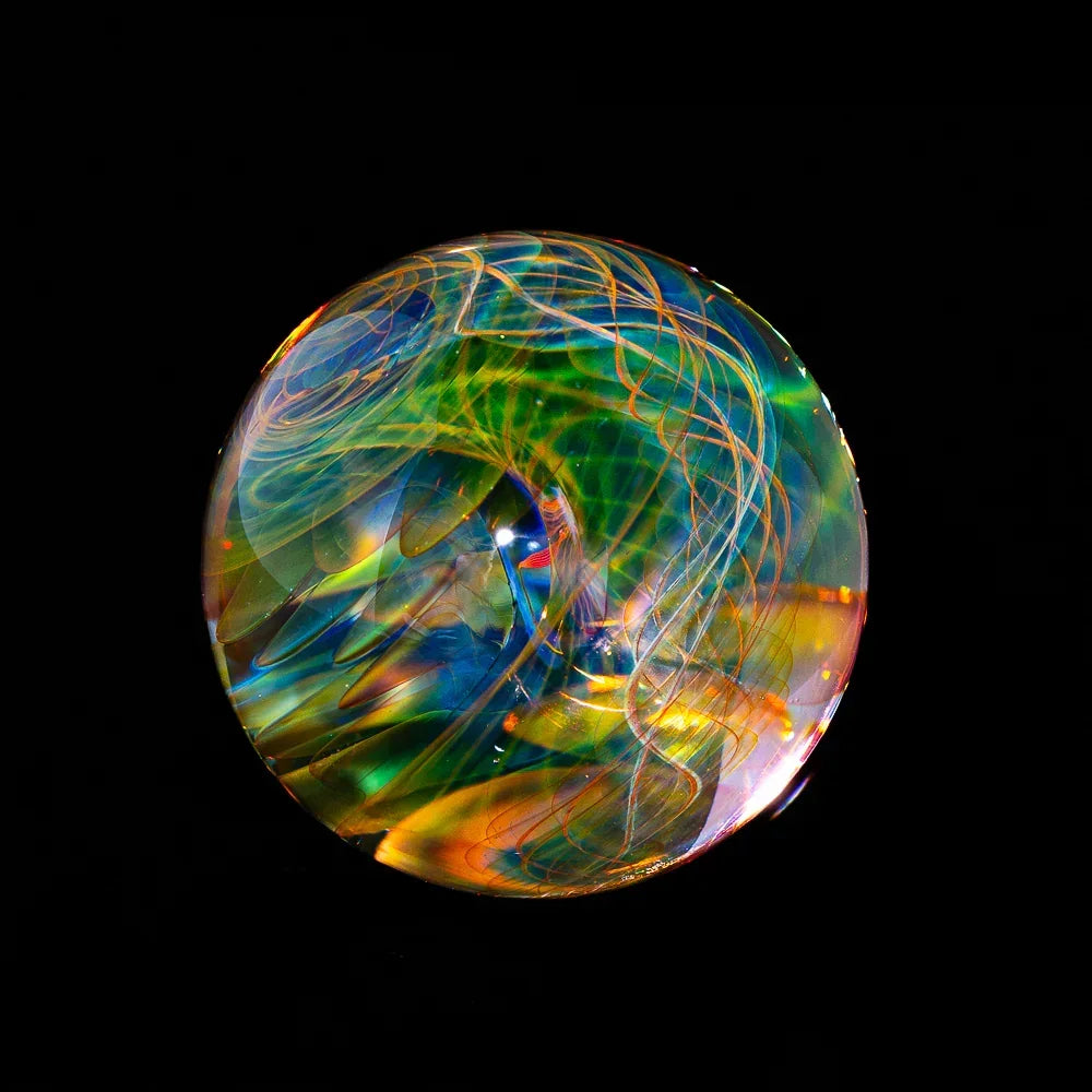 Colorful heady glass marble with swirling patterns on a black background