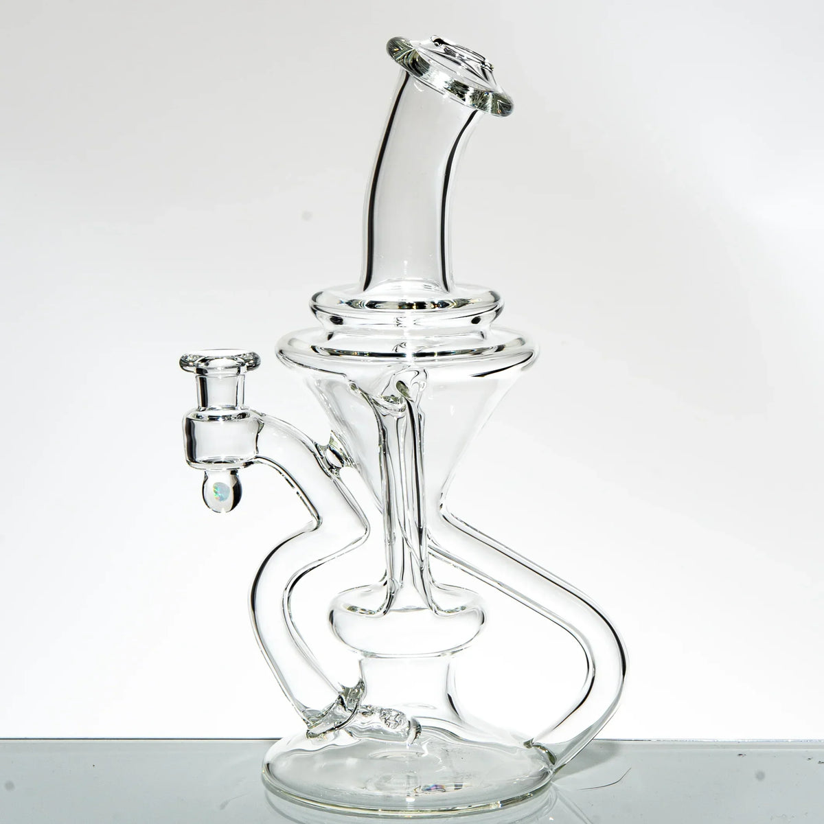 Clear glass double uptake recycler water pipe with intricate curved design on white background