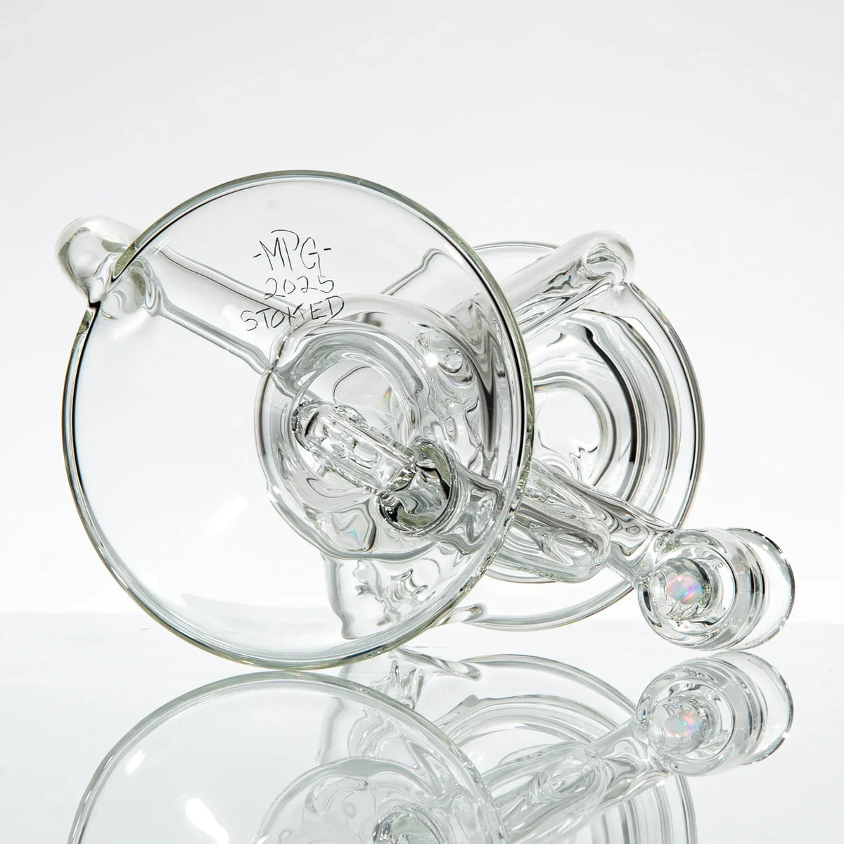 Clear glass recycler water pipe with intricate tubing, artist signature visible on base.