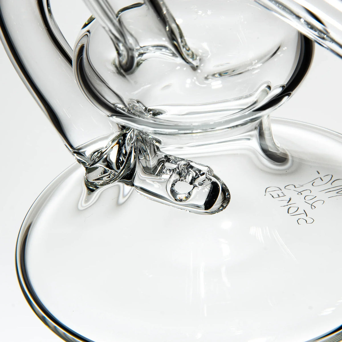 Close-up of clear glass recycler water pipe with intricate glasswork details