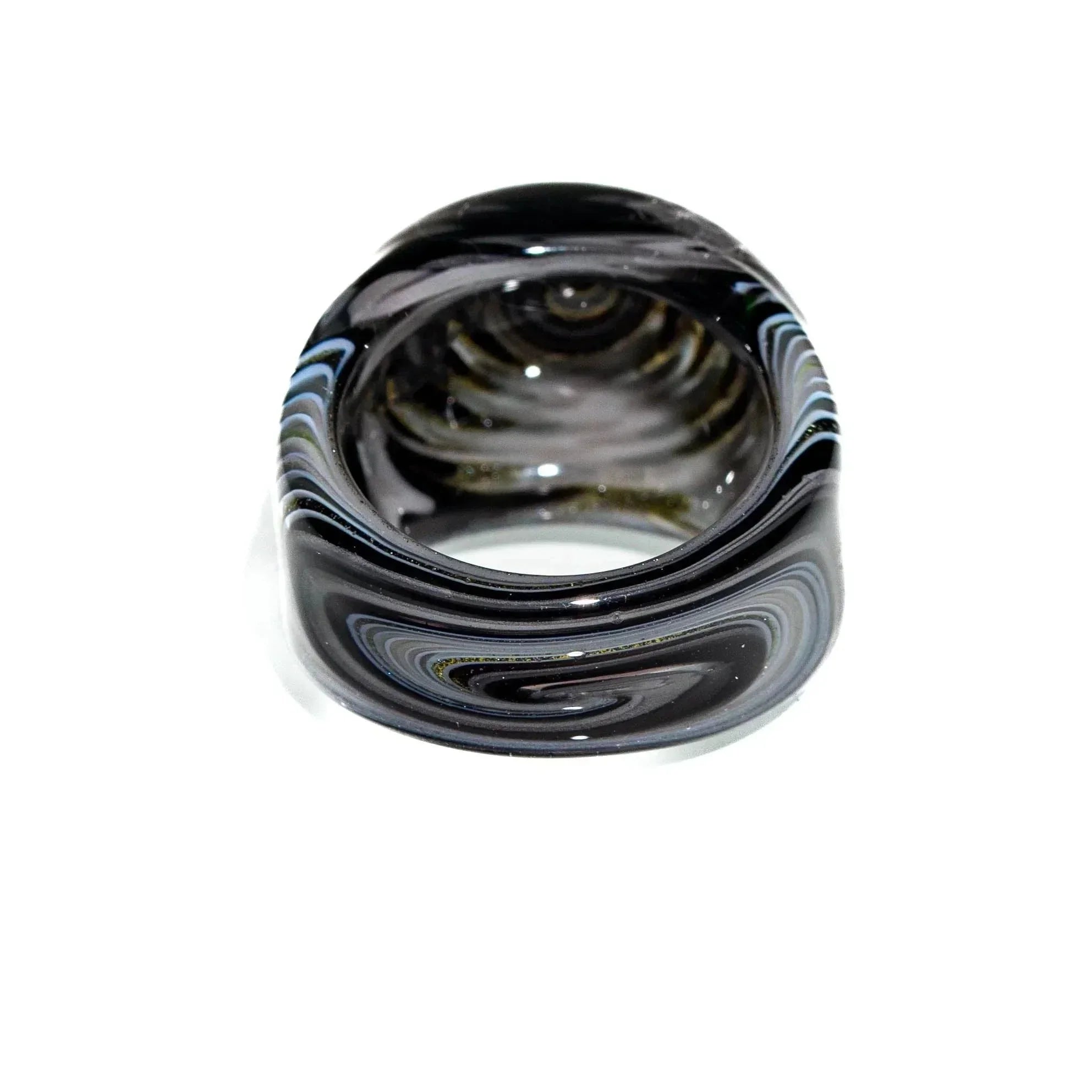 Black and white glass wig wag ring with swirling pattern on white background