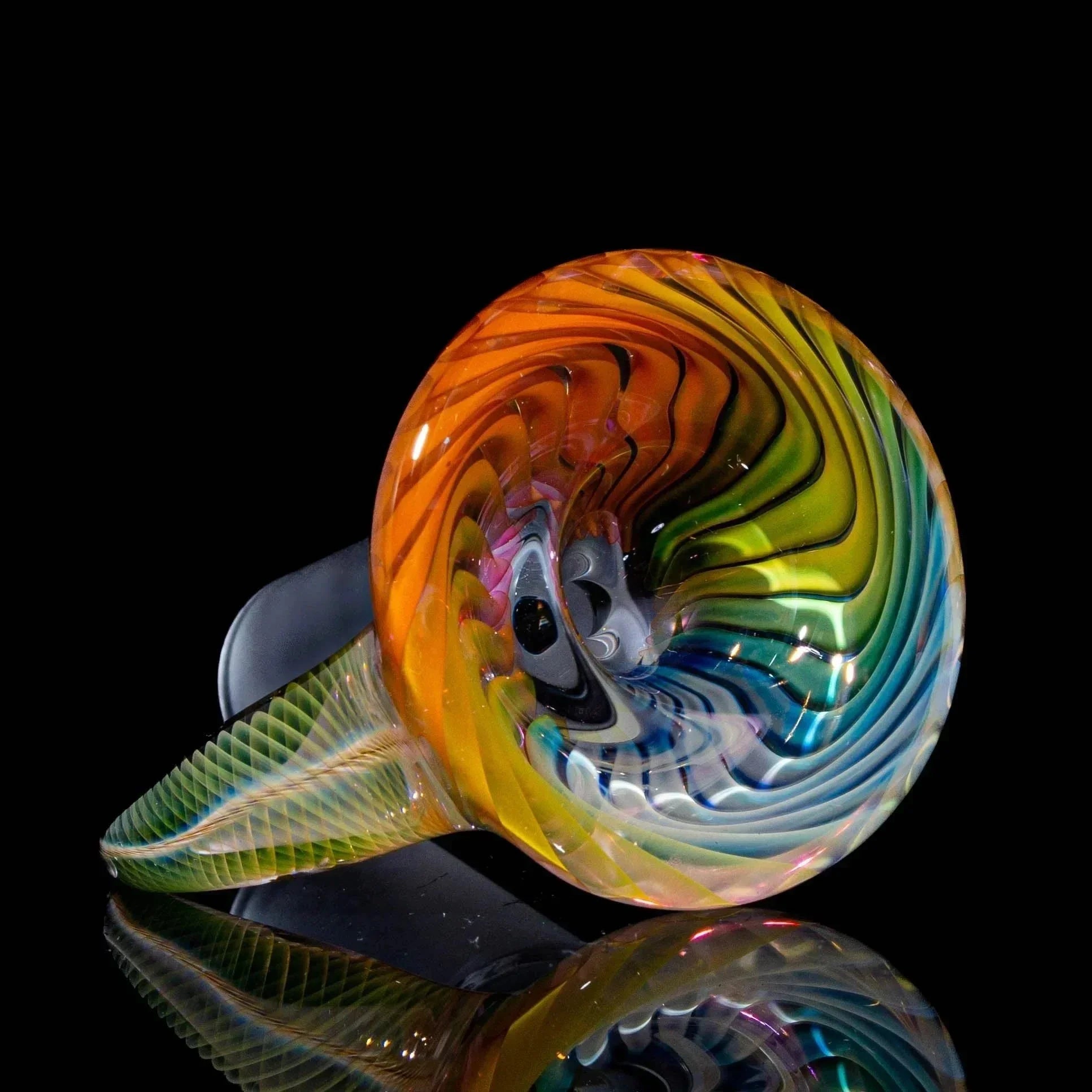 Colorful hand-blown glass horn slide with spiral patterns on a black background