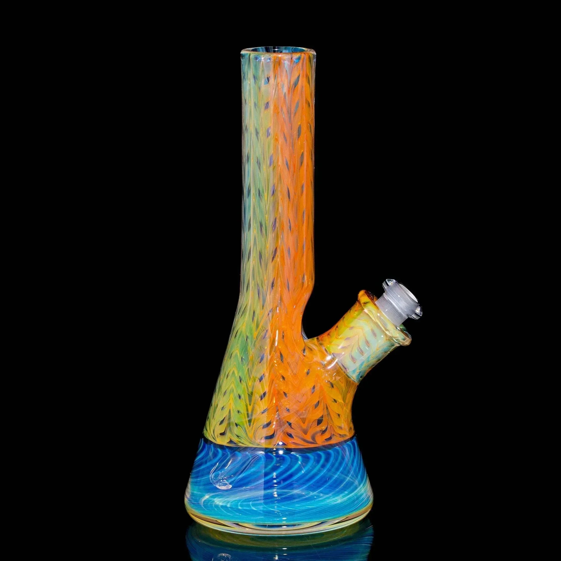 Colorful glass water pipe with orange and blue spiral design on black background