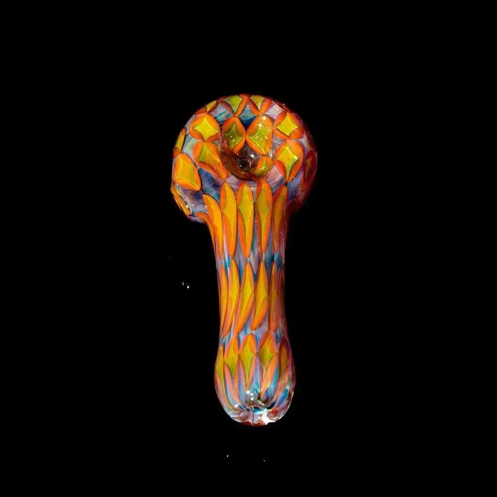 Colorful glass hand pipe with geometric patterns on a black background