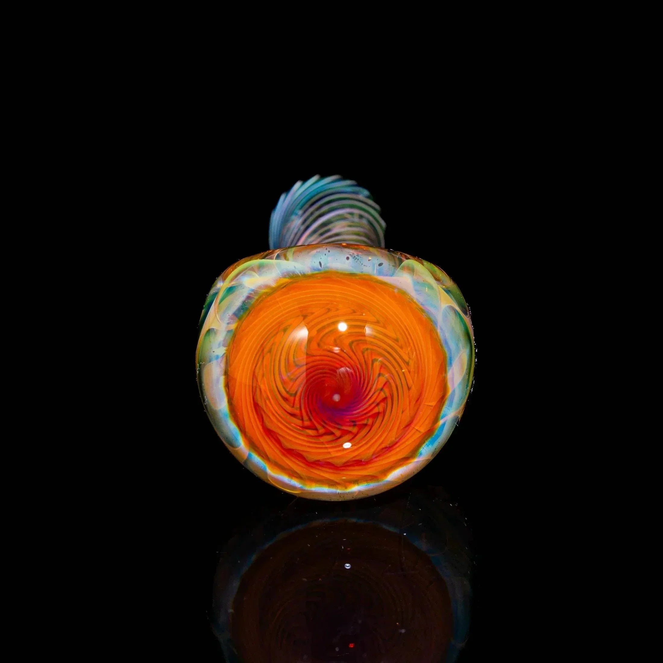 Heady glass spoon pipe with vibrant orange and red swirl design on black background