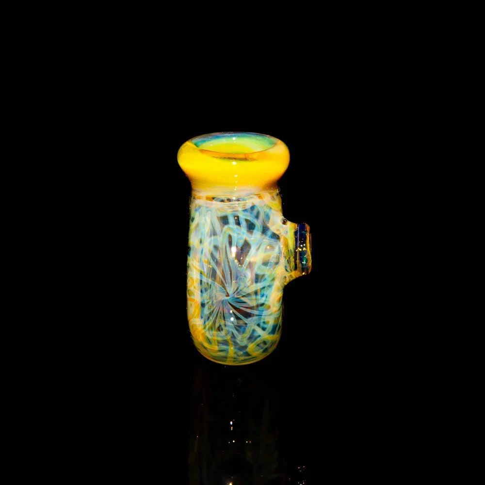 Colorful glass slide bowl with yellow rim and swirling blue wig wag patterns on black background