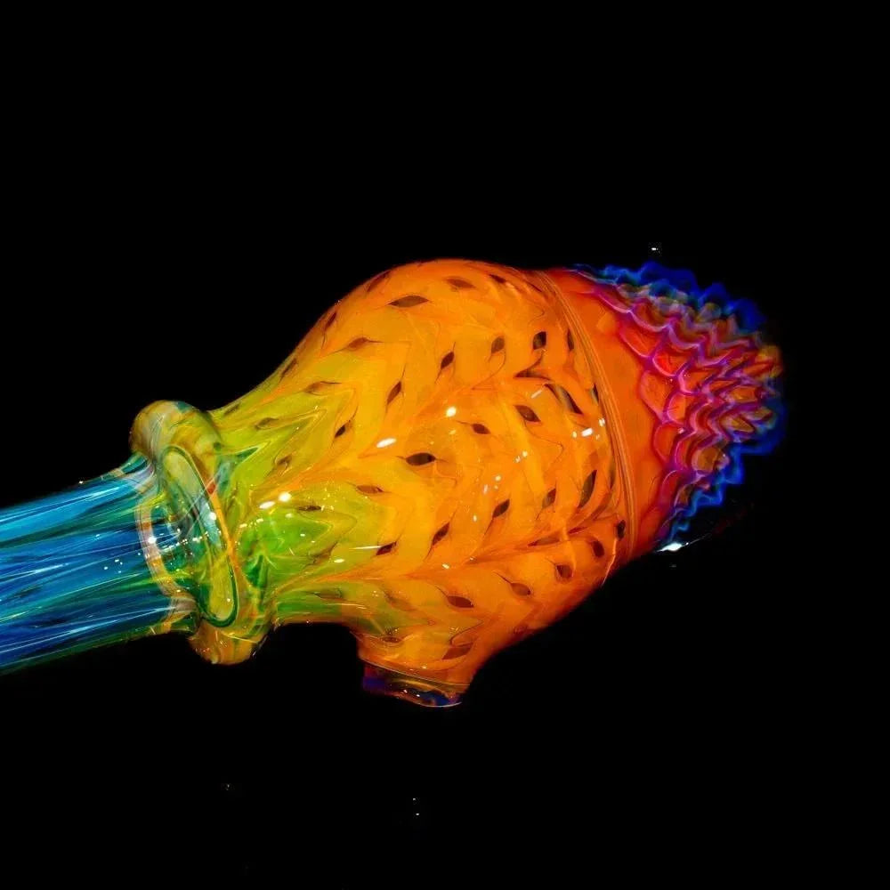 Colorful honeycomb glass spoon pipe with intricate implosion design on black background