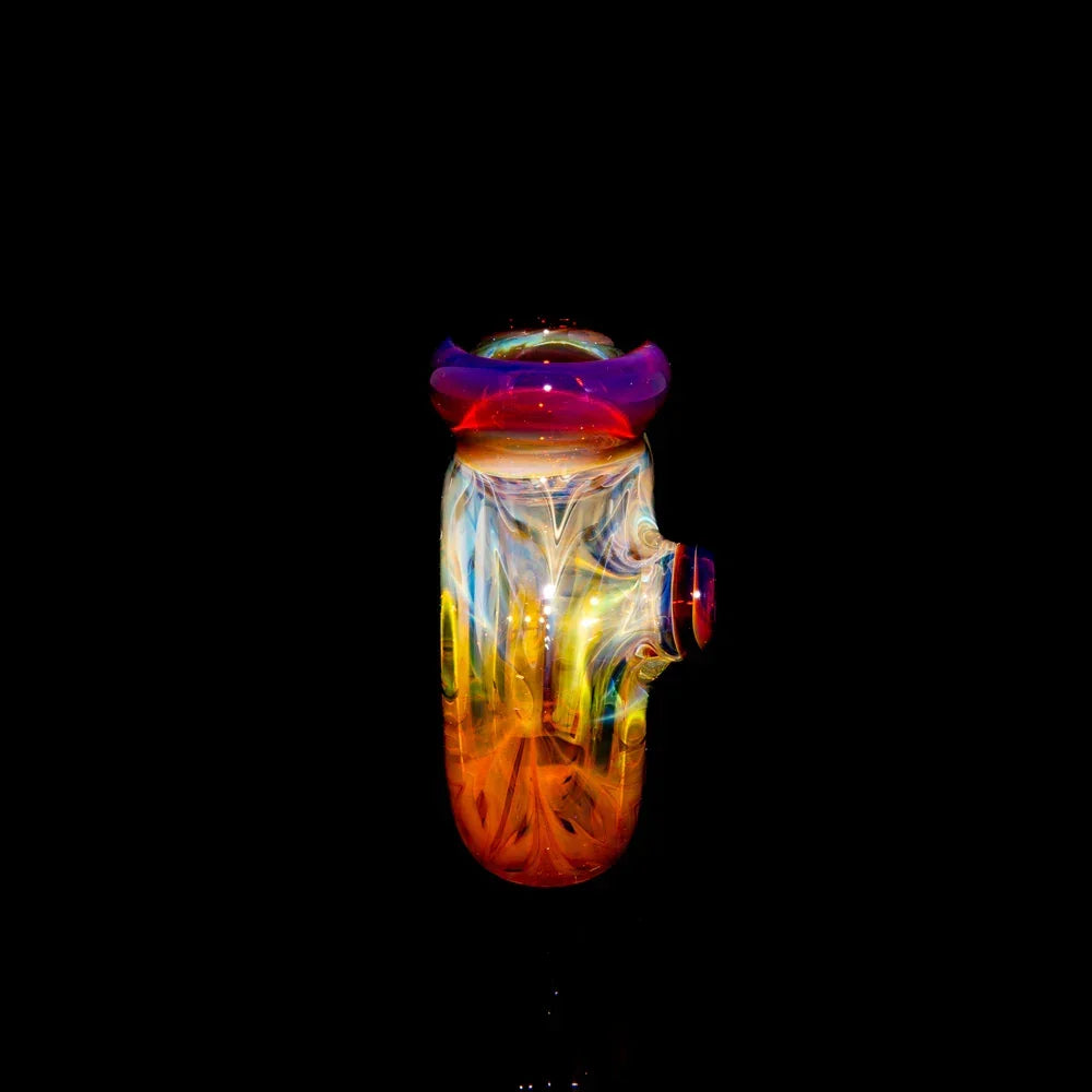 Colorful heady glass pipe with vibrant orange, yellow, and purple swirls on black background
