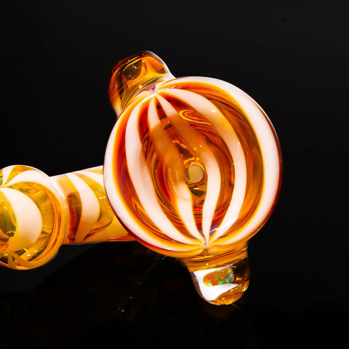 Amber and purple glass sherlock pipe with opal accent, spiral linework, on black background.