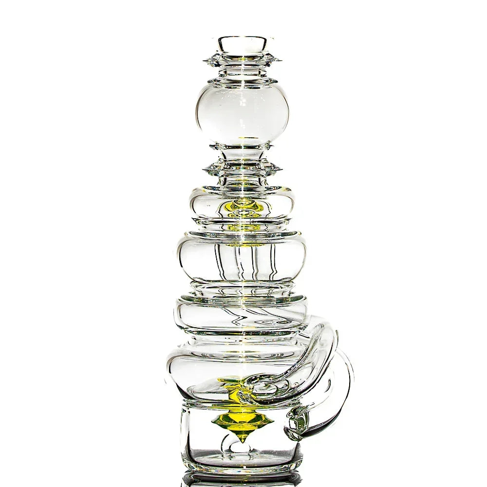 Clear glass water pipe with stacked chamber design and yellow accent, on white background.