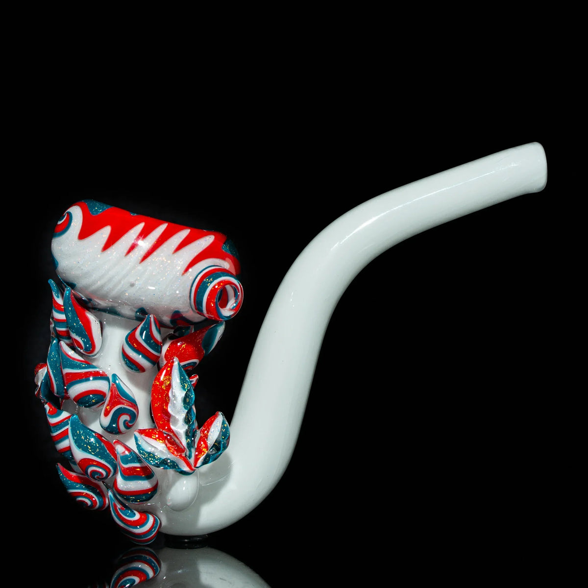 Colorful glass pipe with red, white, and teal swirl accents on black background