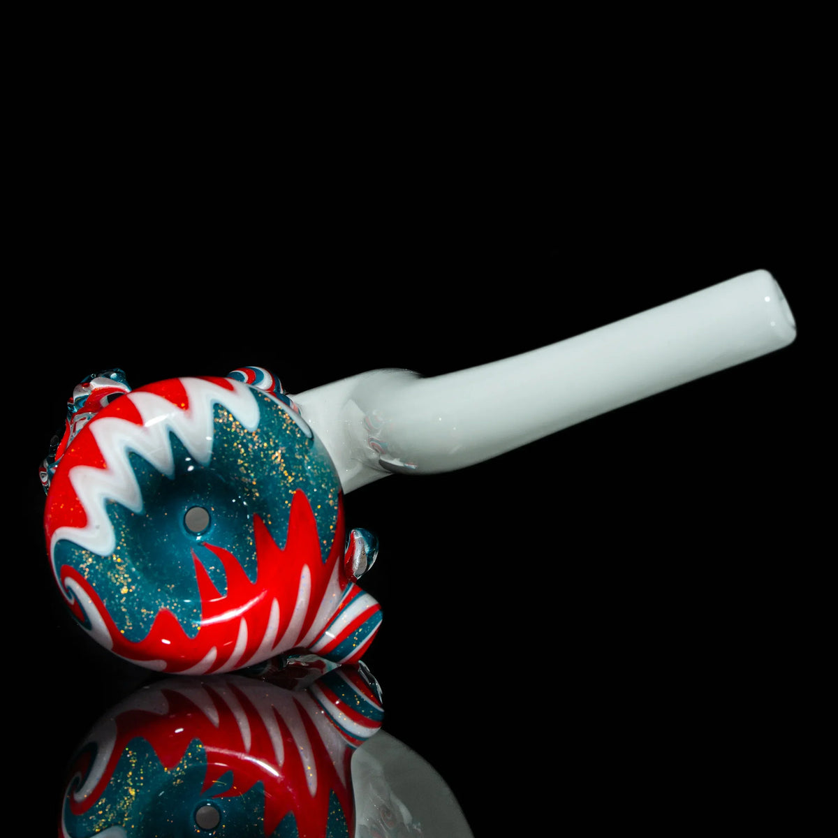 Colorful glass hand pipe with red, white, and teal swirl design on black background