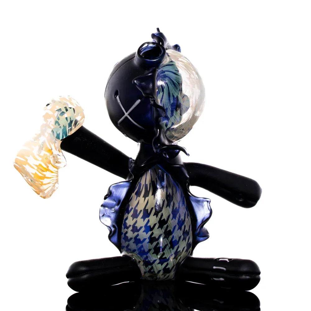 Handcrafted houndstooth-patterned glass art doll with mixed blue and yellow accents, sitting pose
