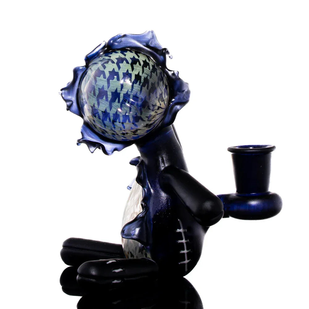 Artistic glass sitting doll pipe with blue houndstooth pattern and stitched details
