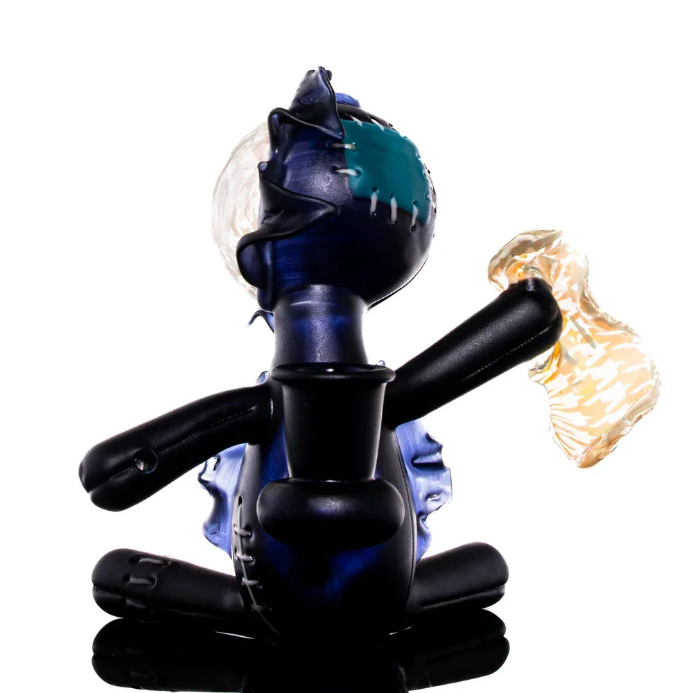 Handcrafted glass art doll with houndstooth pattern, dark blue and black, sitting pose