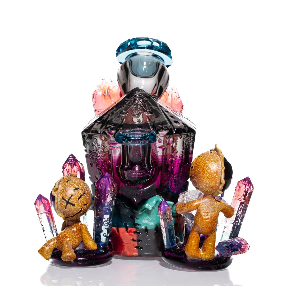 Heady glass art piece with colorful crystals and two doll-like figures, vibrant unique design