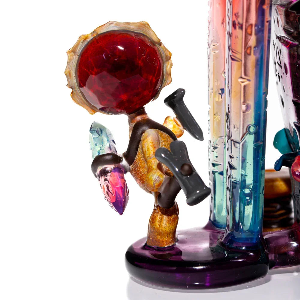Intricate heady glass art figure with a red gem head and colorful crystal details