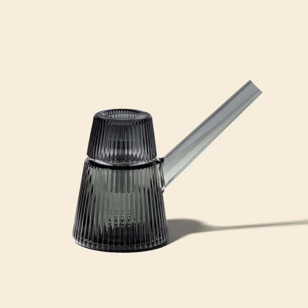 Modern charcoal bubbler with ribbed glass design and angled mouthpiece on beige background